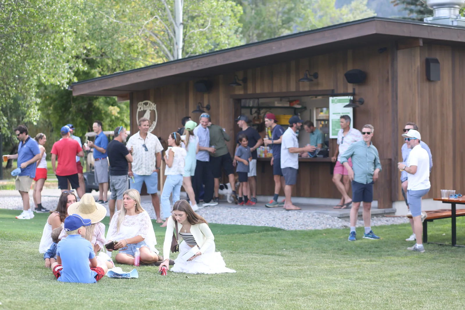 Guests on the lawn at The Commons, with Birdie's Snack Shack behind them