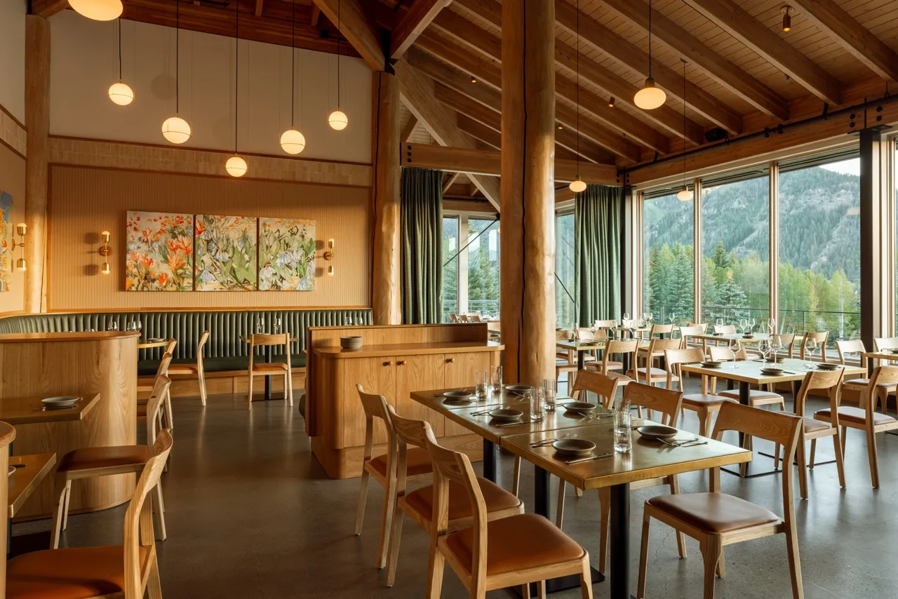 The main dining room at Timbers with timber beams and floor-to-ceiling windows
