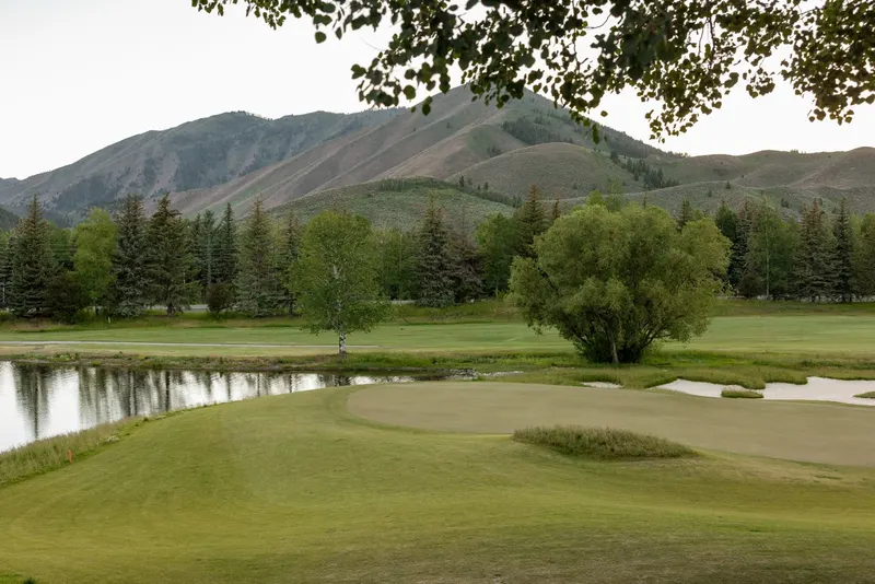 The patio at Timbers overlooking the ninth green and the mountains